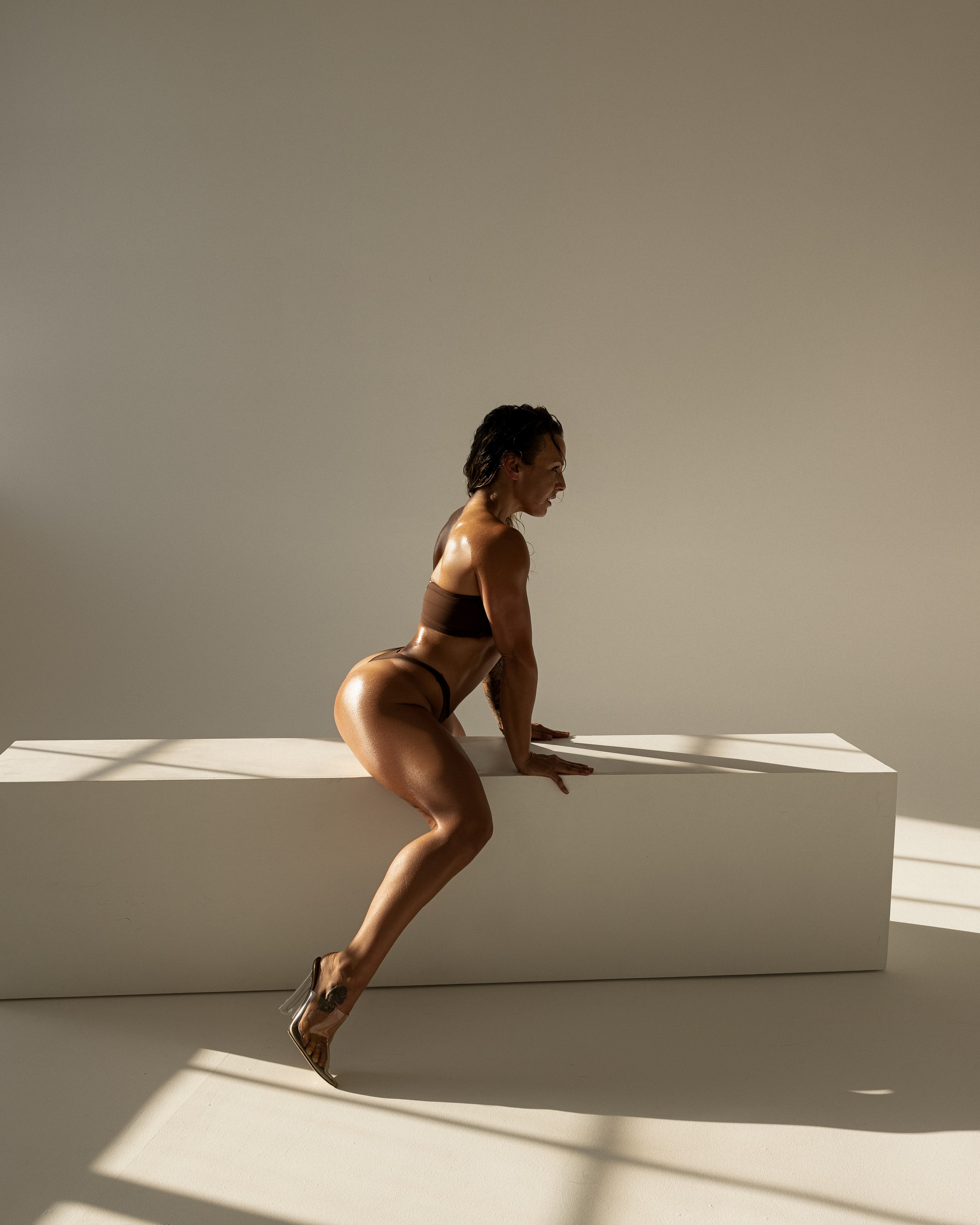 Lauren Saracione in hot pink bodysuit in a lunge position demonstrating movement and structure